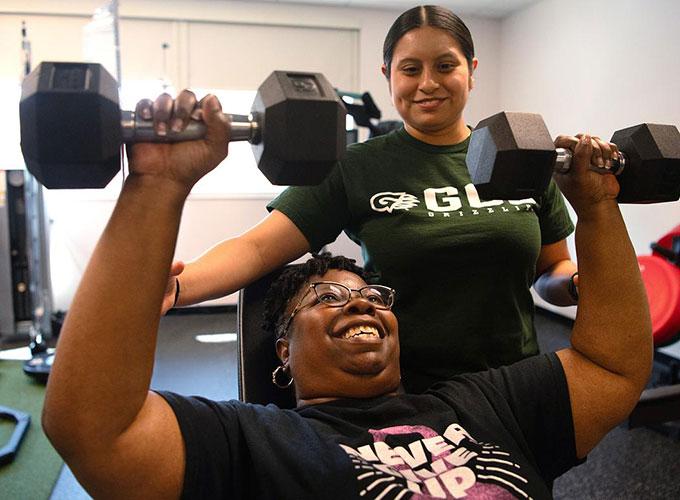 Zulaykha Lemus-Vazquez spots Laura Taylor as they work out during the Free Fitness Program