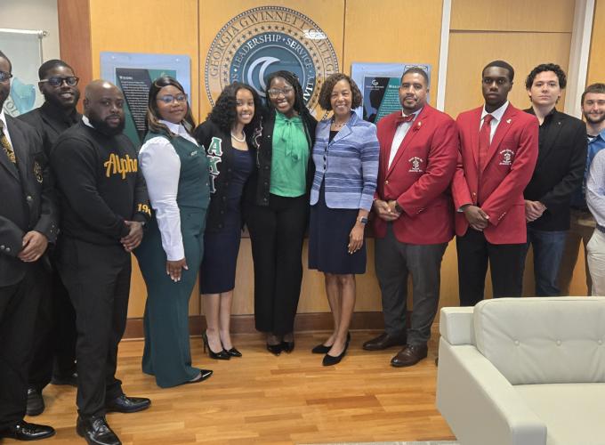President Jann Joseph poses with student members of Georgia Gwinnett College's on-campus Greek organizations in the presidential suite