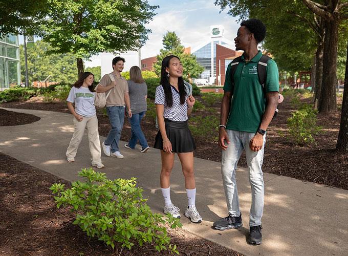GGC students between classes walking near the library