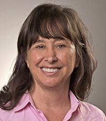 Dr. Lorraine Jonassen wearing a pink blouse and smiling at camera