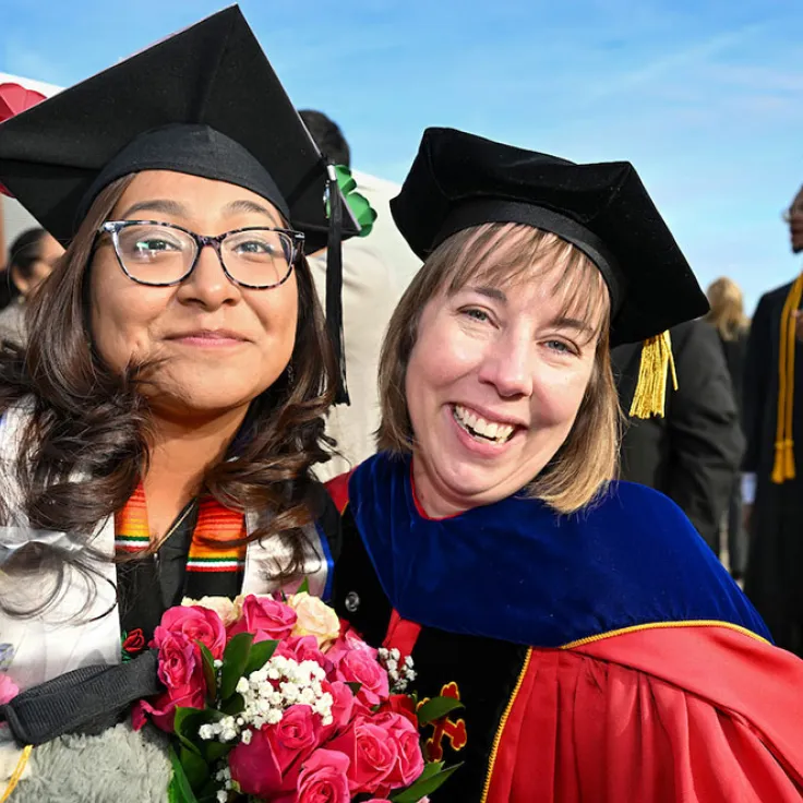 GGC grad posing with faculty member