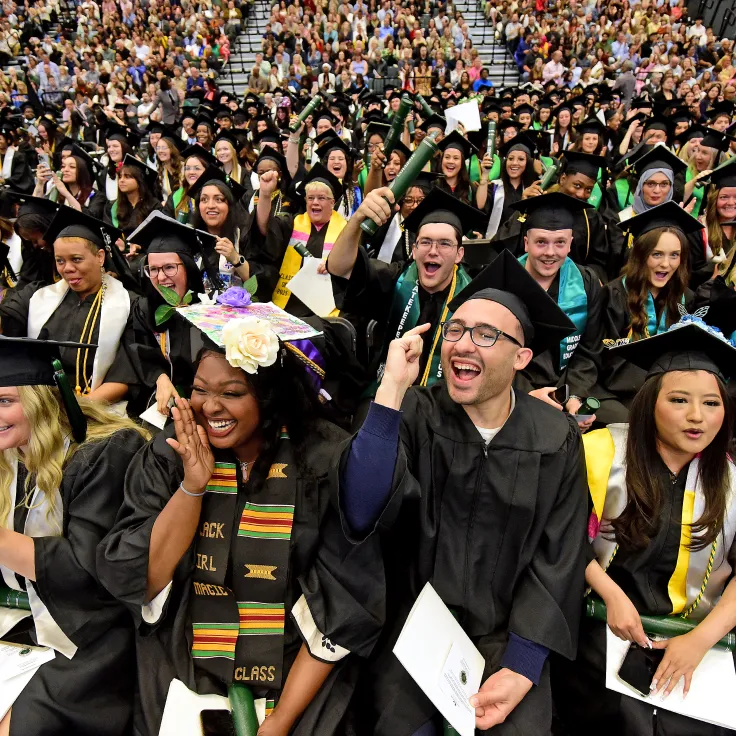 Graduates smiling during the commencement ceremony