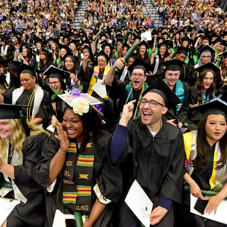Graduates smiling during the commencement ceremony