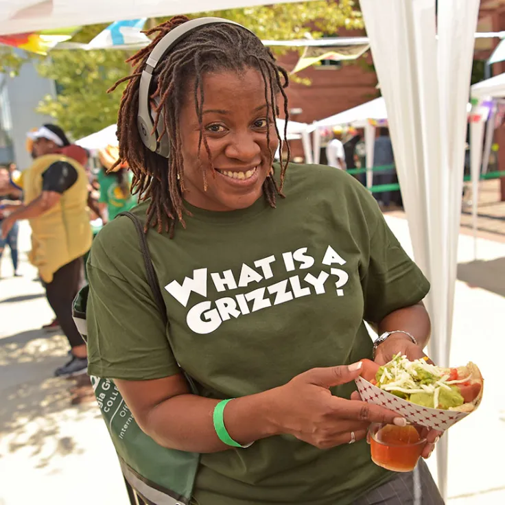 student wearing "What is a Grizzly? t-shirt at International Hot Dog Festival