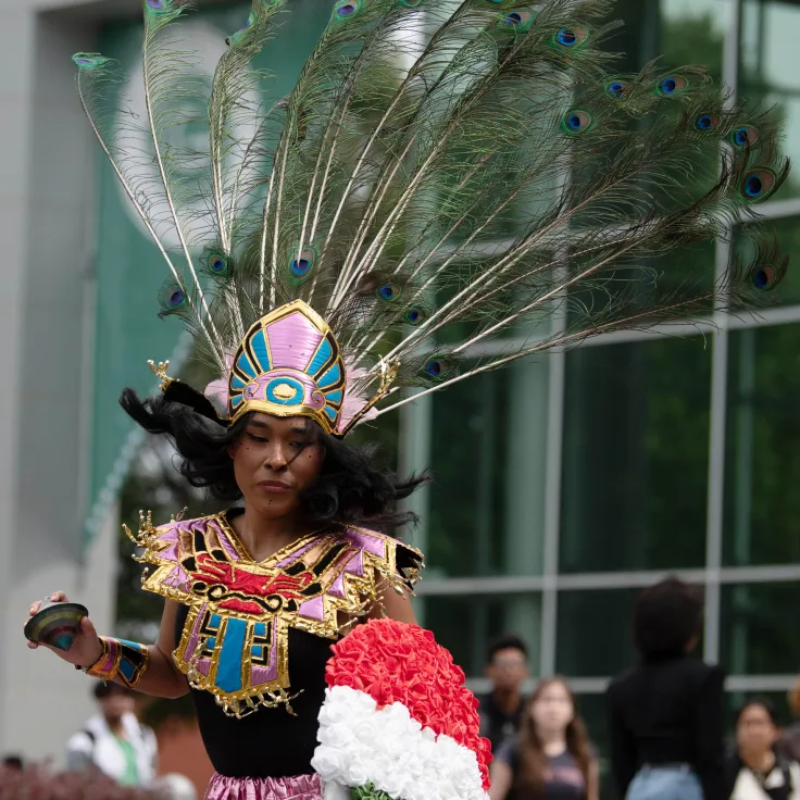 A Hispanic student wearing ceremonial dress during a performance