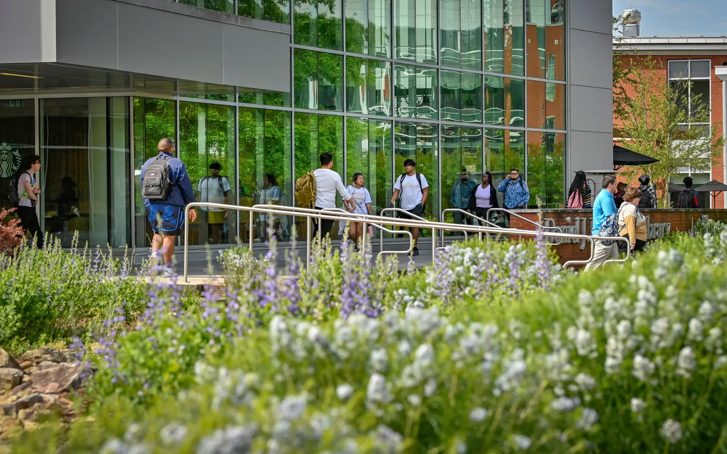 Students walking in front of the library