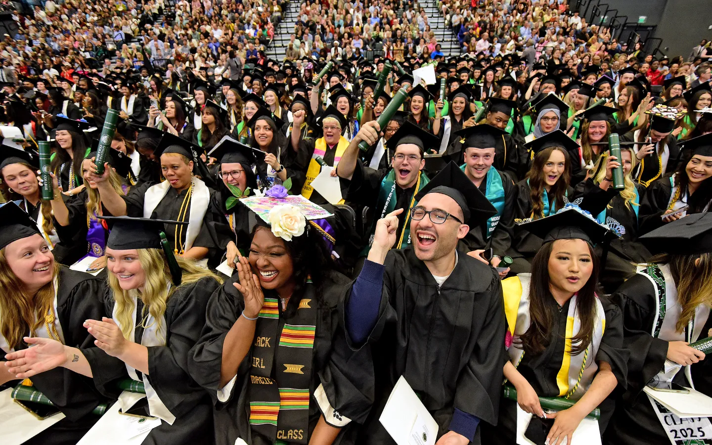 Graduates smiling during the commencement ceremony
