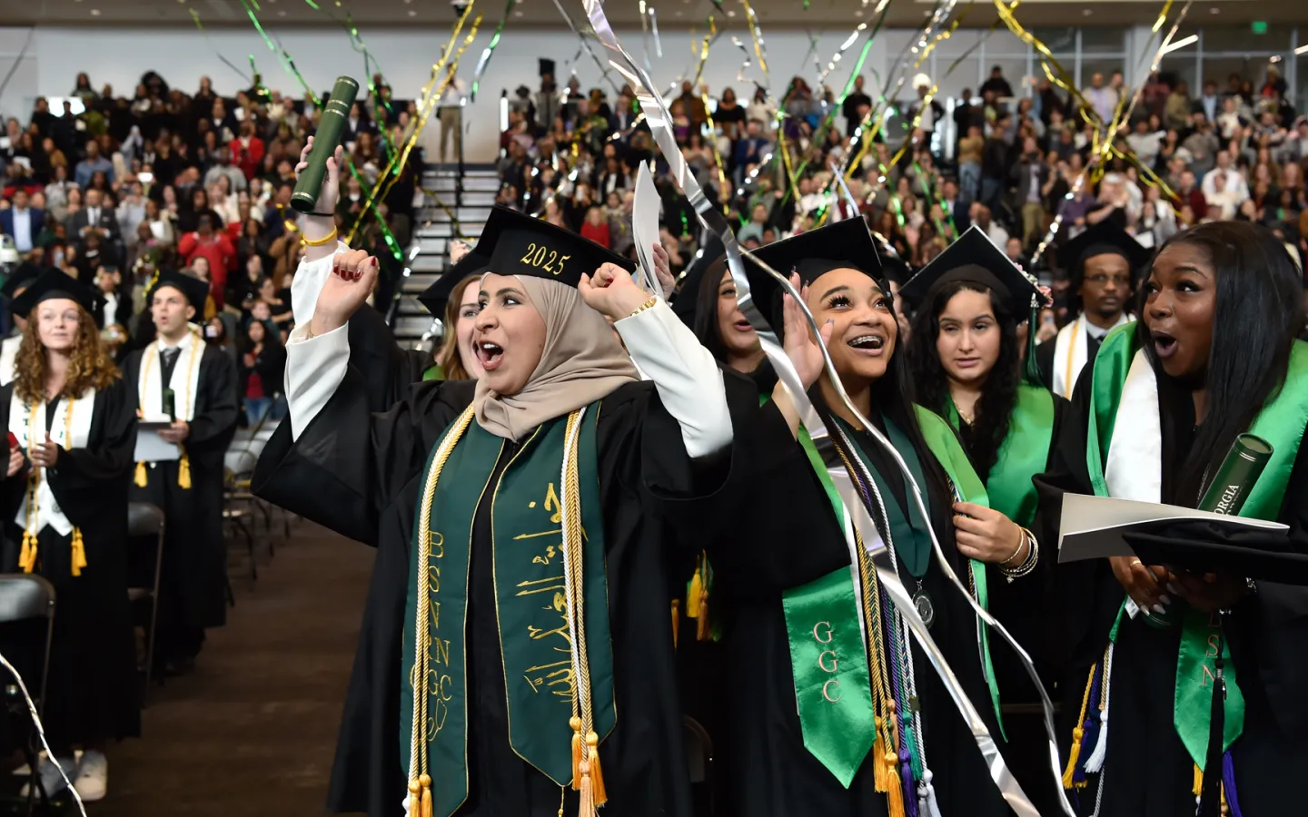 Graduates cheering at their commencement ceremony