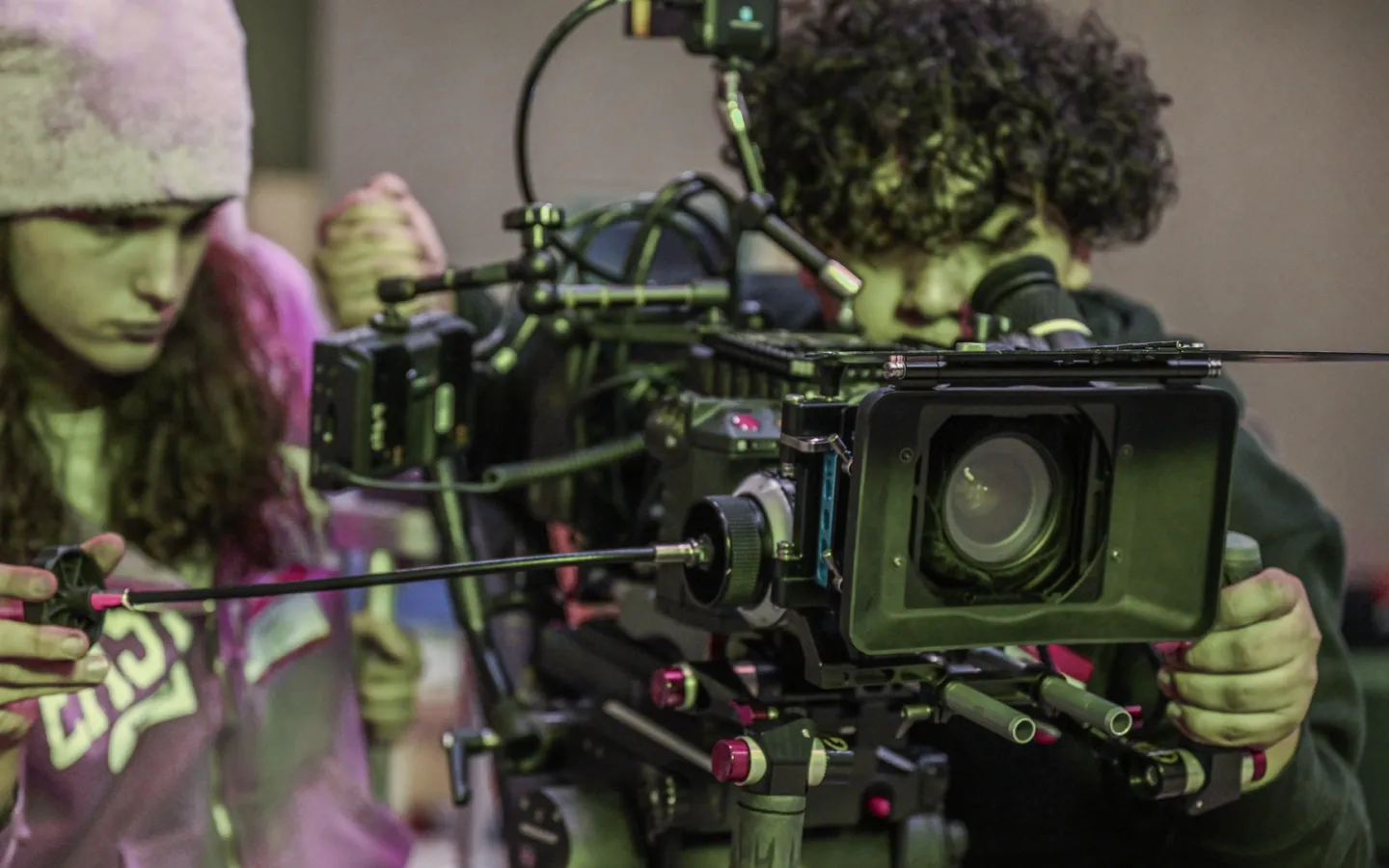 Two students using a professional video camera