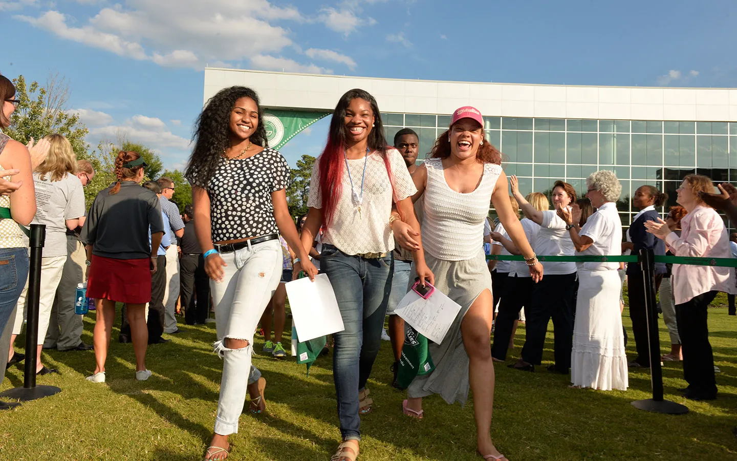 3 new students walking through welcome link during orientation