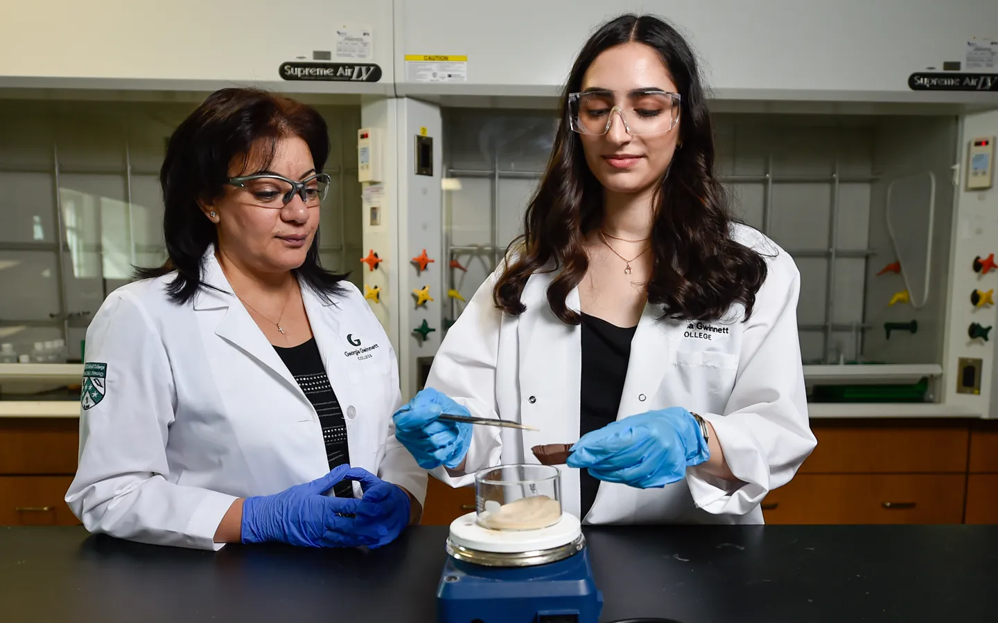 A student and professor work in a biology lab