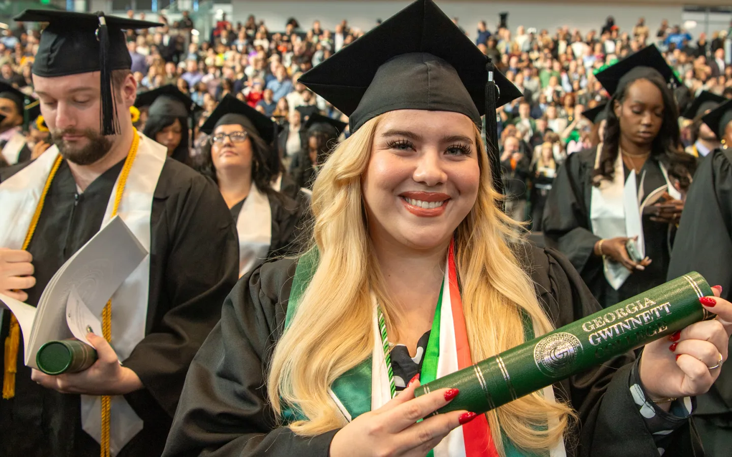 Fall 25 graduate Sara Ivanfai holds her diploma