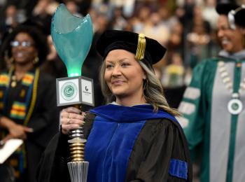 Dr. Maryann White carries mace at the fall 2024 commencement ceremony