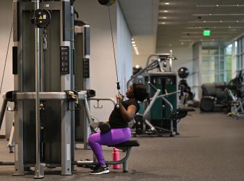 Niecia Say works out on the cable machine in the fitness area at GGC's Convocation Center