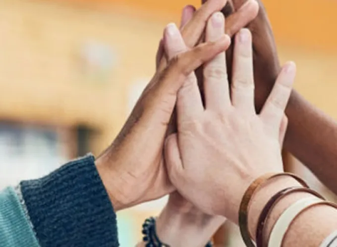 Hands raised up in group high-five