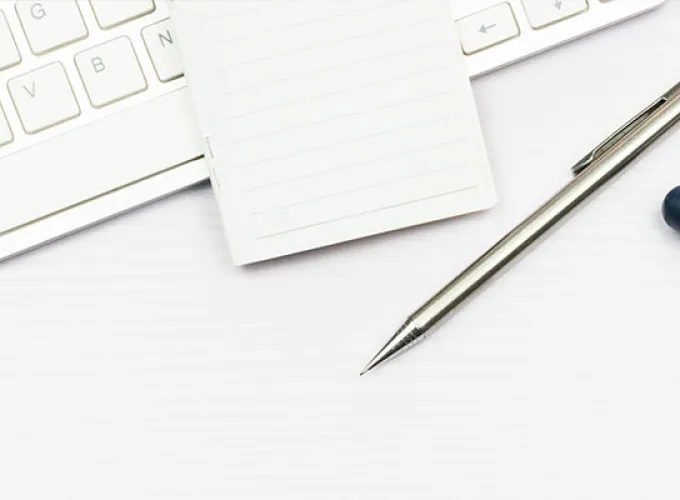 desktop with plant, computer keyboard, stethoscope, pen