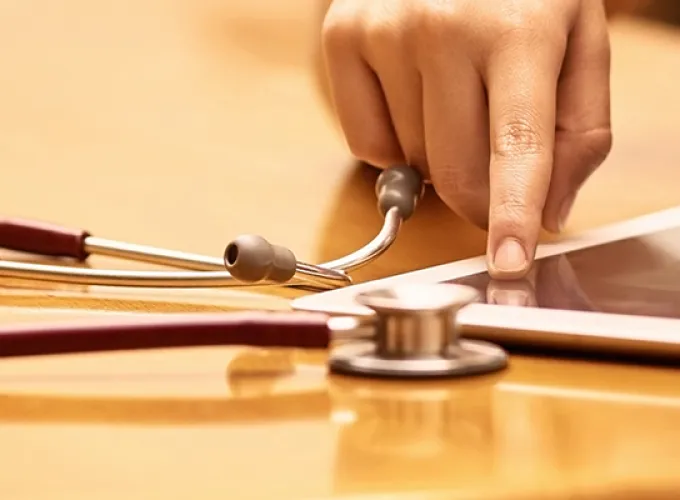 stethoscope and tablet on desktop