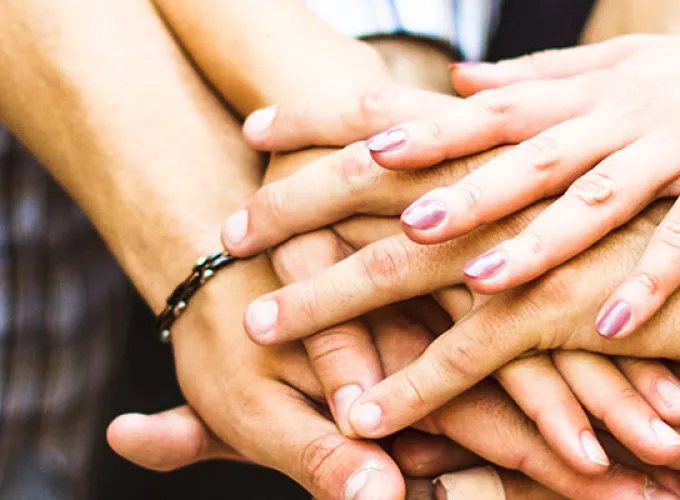Student circle with hands all in