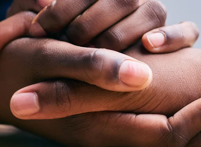 Caring hands of two people