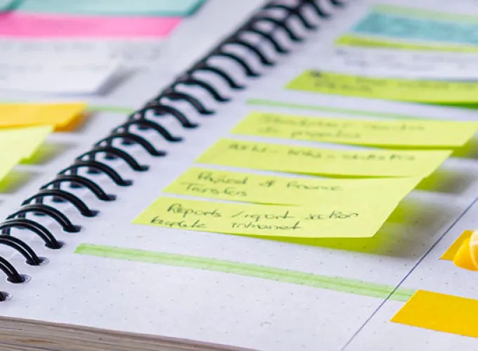 hand highlighting dates in planner