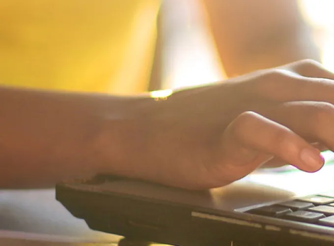person typing on laptop