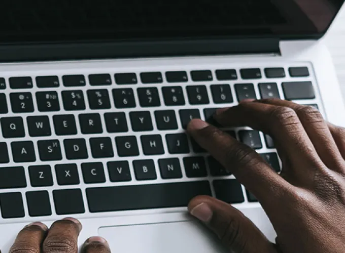 person typing on laptop