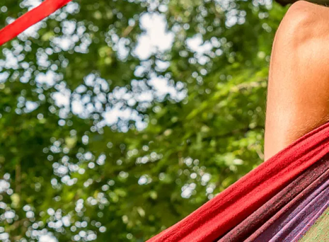 student relaxing in pop-up hammock