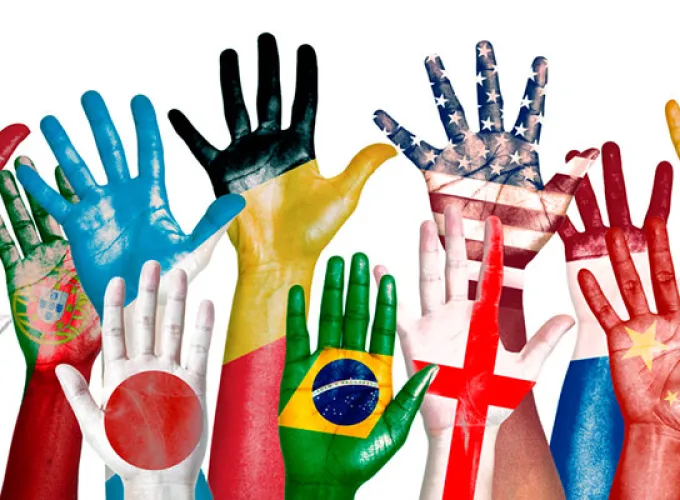 raised hands painted with international flags