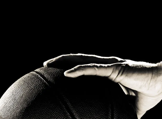 hand holding a basketball, black and white image