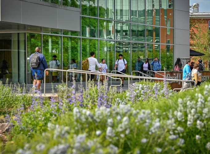 Students walking in front of the library