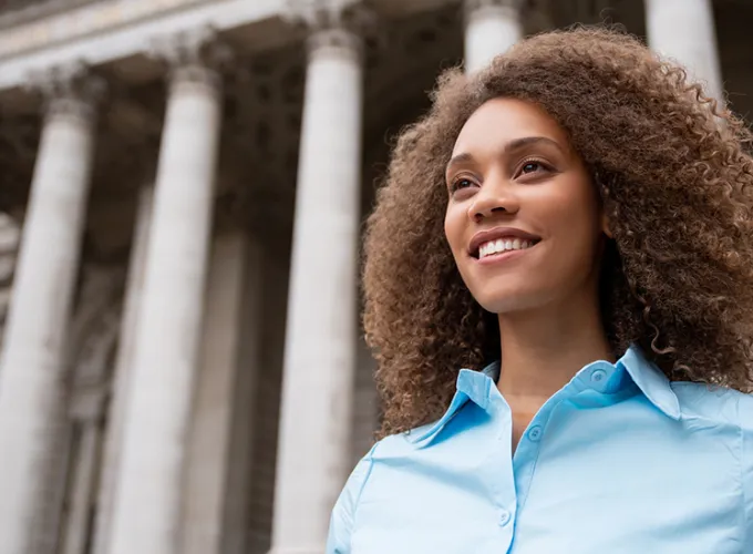 Female student in front of columned government building
