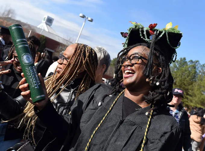GGC grads celebrating outside after ceremony
