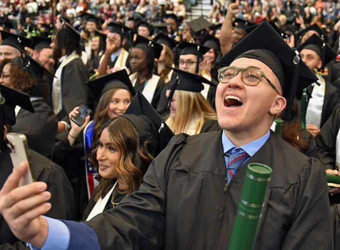 GGC grad cheering in crowd