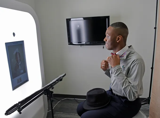 Male student fixing his bowtie for a professional photo
