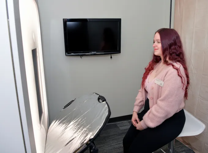Female student posing in the professional photo booth