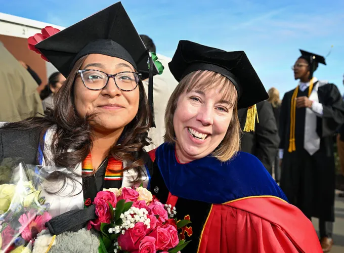 GGC grad posing with faculty member