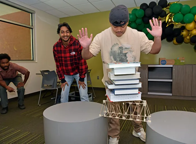 students participating in a physics truss exercise