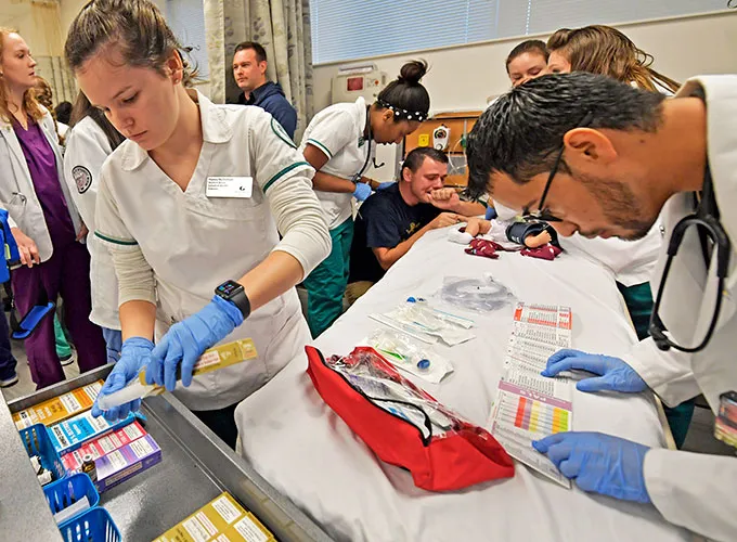 Nursing majors assisting a patient during a mock exercise