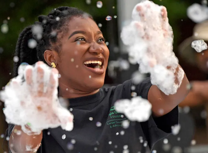 Resident student having fun with bubbles during a housing event