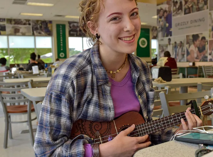 student playing music in the dining hall