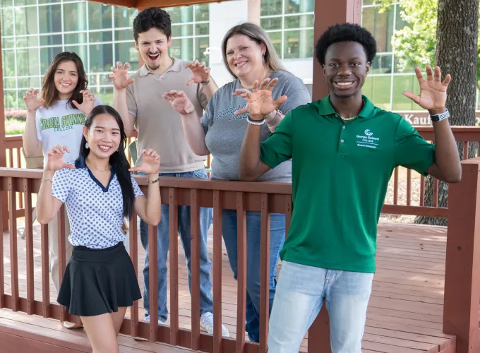 Students holding up hands as claws to signify Grizzly bears