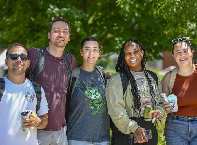 Group of male and female students smiling at the camera