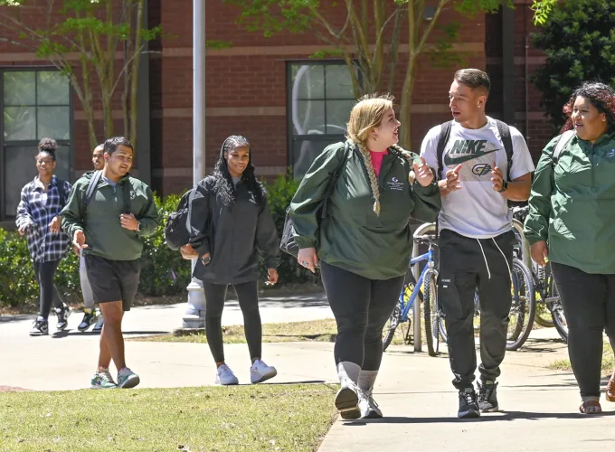 Group of students talking and walking