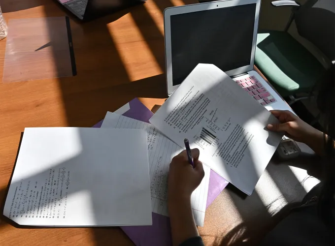 Student writing on a paper