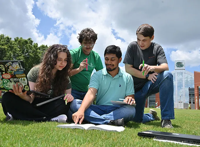 4 students collaborating and studying on GGC's Lawn