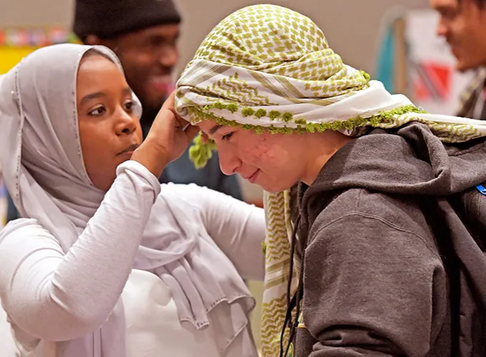 one person demonstrating how to fashion head covering