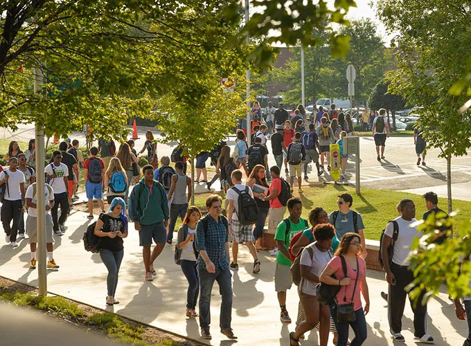 students walking between classes on an active campus