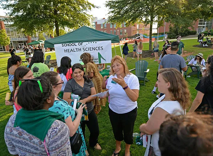 GGC faculty speaking with freshmen and parents at Grizzly Orientation