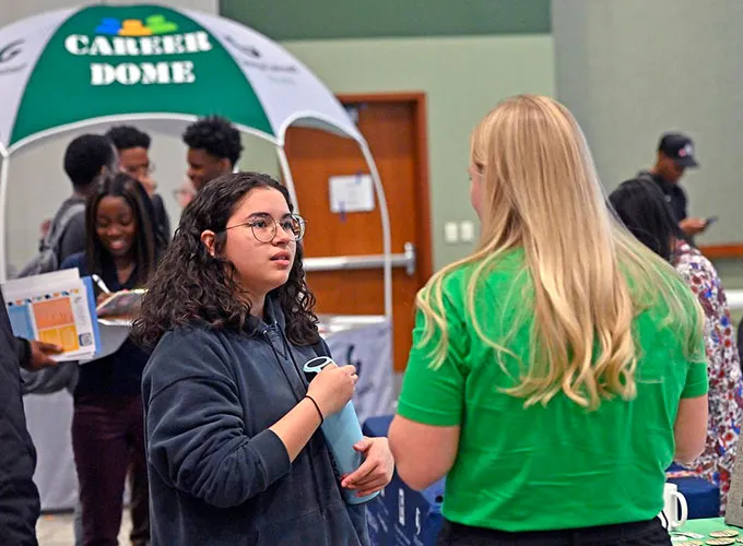 student talking with employer at GGC's Career Fair