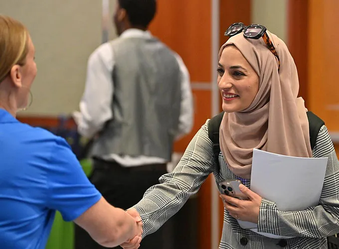 GGC student shaking hands with an employer attending a career fair